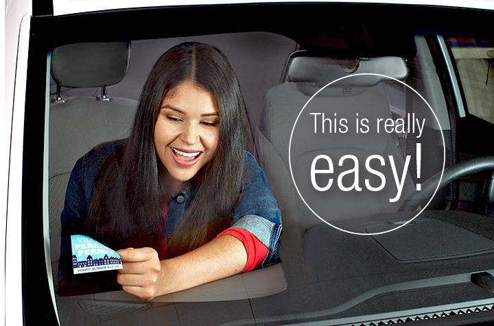 Young woman makes a windshield sticker easily removable with sticker shield.